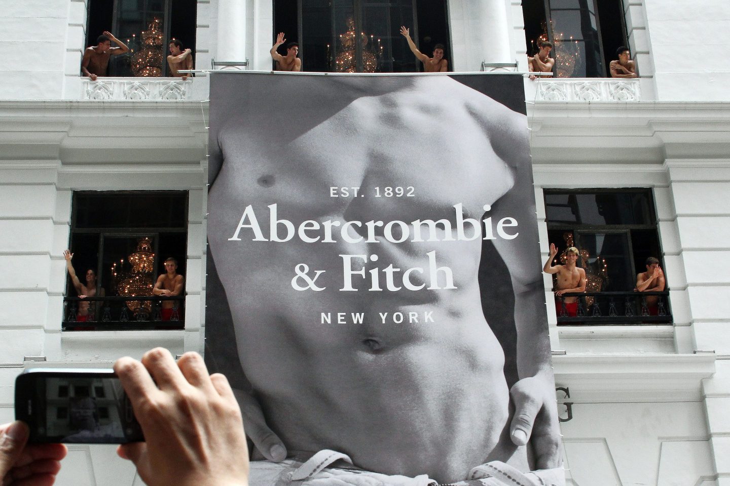 Large Abercrombie & Fitch sign featuring a man's unclothed torso